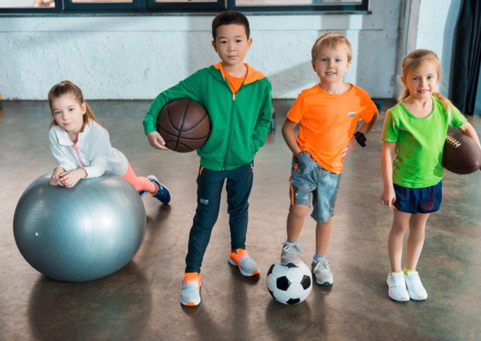 Groß (child-lying-on-fitness-ball-next-to-multiethnic-ch-2024-11-14-16-18-38-utc)